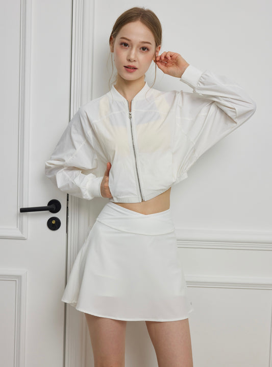 Woman wearing ISLAHOLA Aero Jacket lightweight cropped active jacket in Studio White